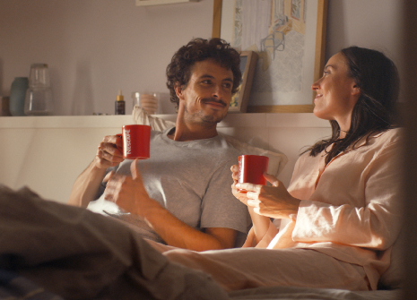happy couple in bed drink coffee